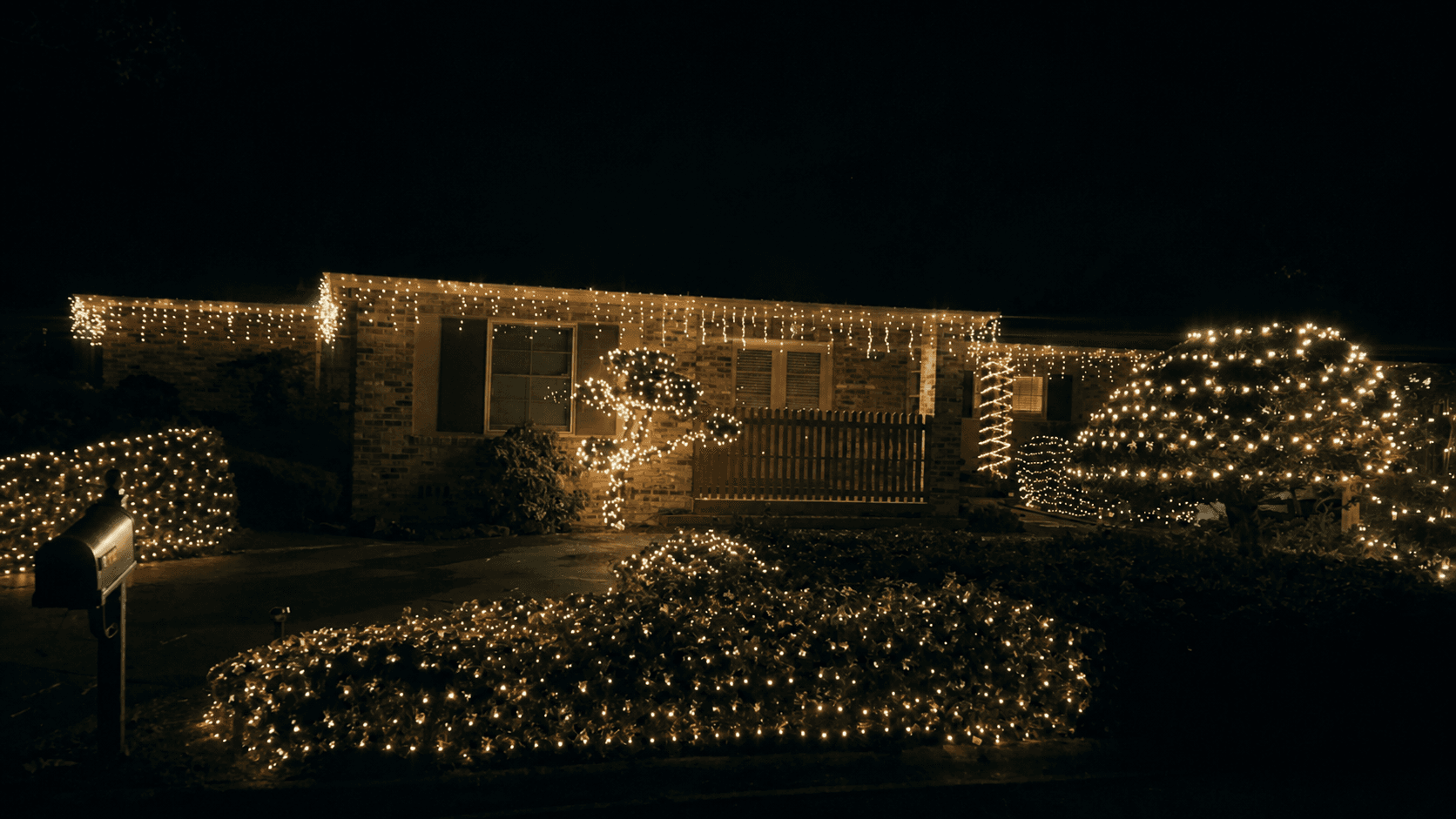 Brick Ranch with Icicle Lights & Wrapped Landscape