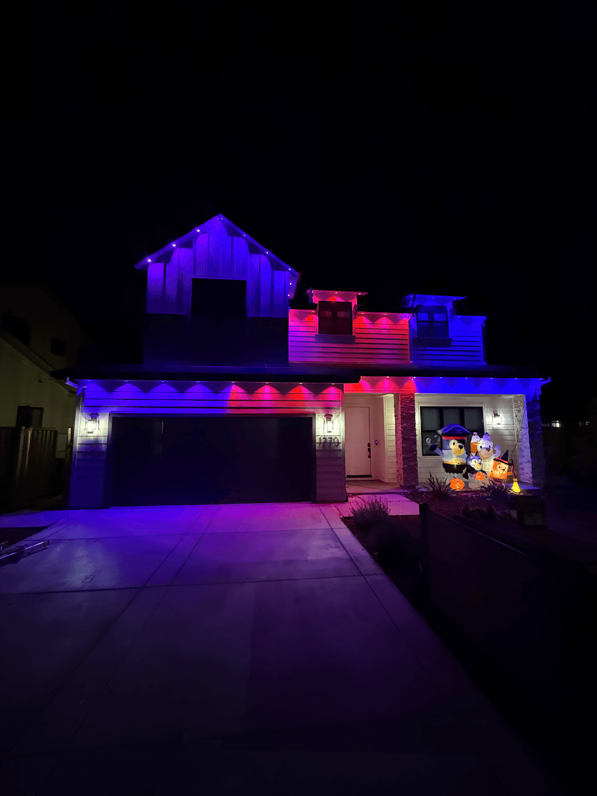 Modern farmhouse with blue and purple smart roofline