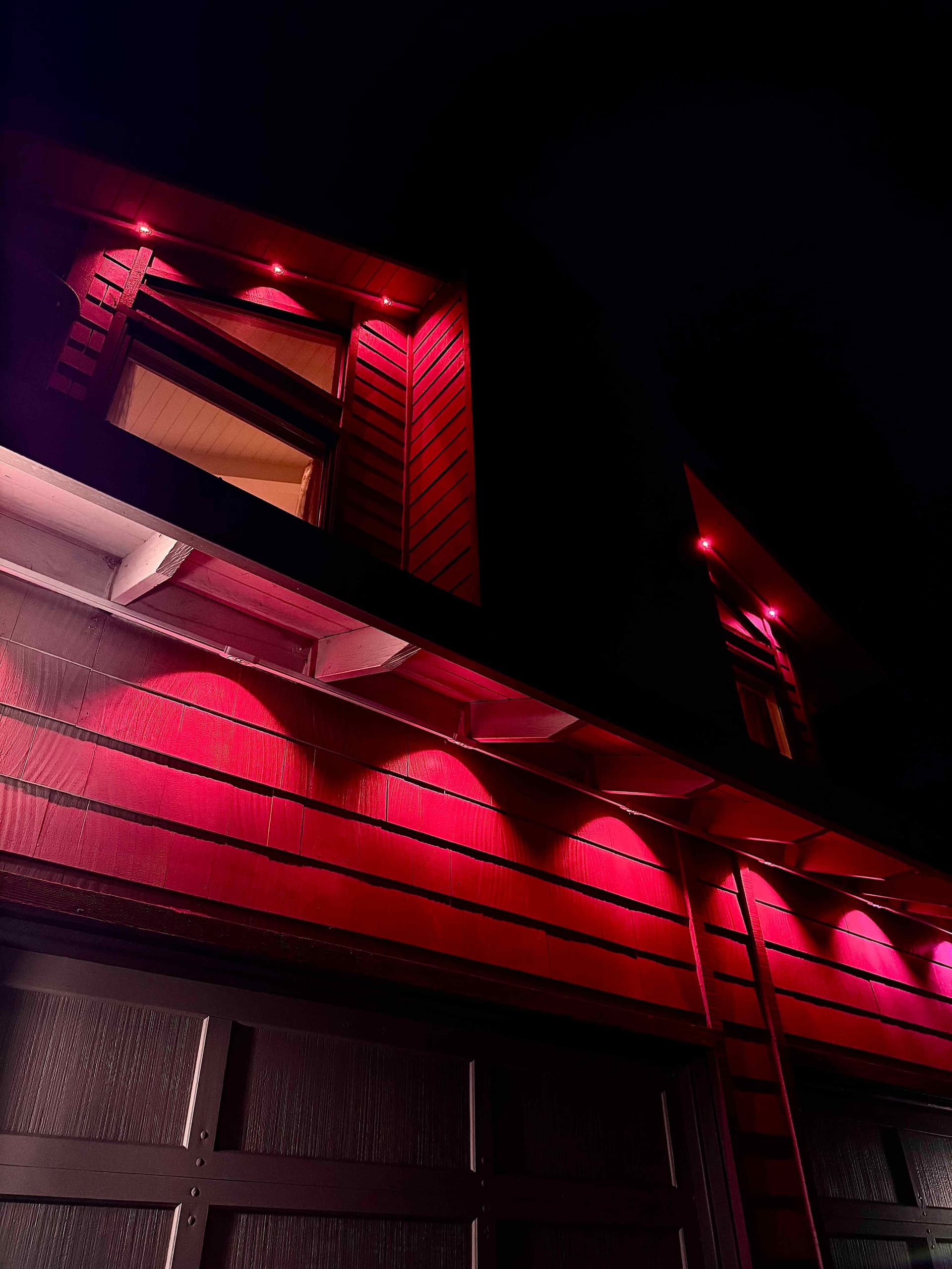 Home exterior at night washed entirely in vivid red by individually-controlled Govee eave lights